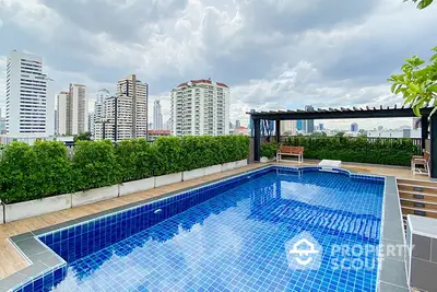 Stunning rooftop pool with city skyline view, perfect for relaxation and entertainment.