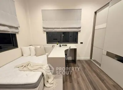 Modern bedroom with built-in desk and storage, featuring sleek design and cozy ambiance.