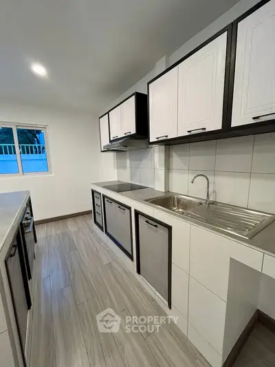 Modern kitchen with sleek cabinetry and stainless steel sink