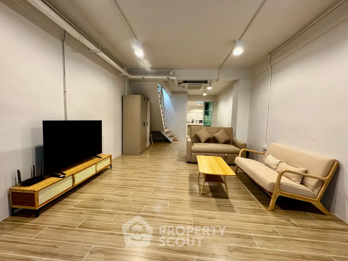 Spacious modern living room with stylish furniture and wooden flooring