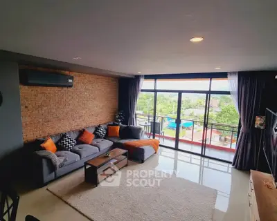 Spacious living room with modern decor and large windows offering scenic views.