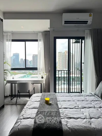 Modern bedroom with city view, featuring a cozy bed, desk, and balcony access.
