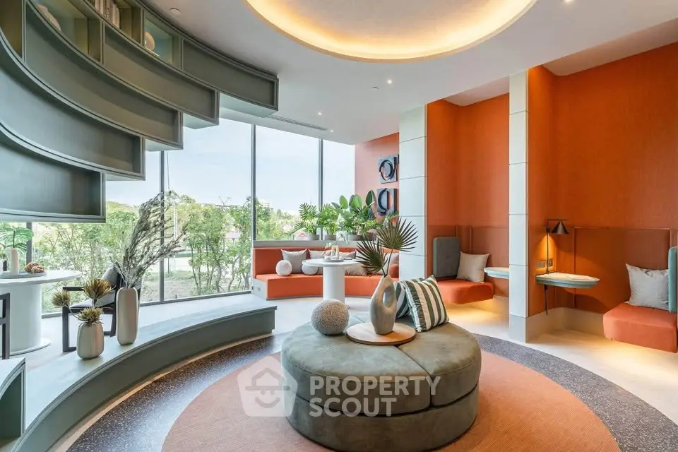 Modern living room with stylish decor and large windows offering garden views.