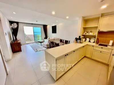 Spacious open-plan living room with modern kitchen and balcony view