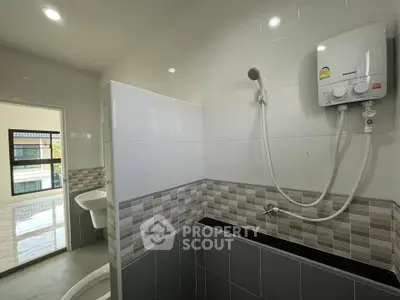 Modern bathroom with water heater and stylish tile design in a contemporary home.