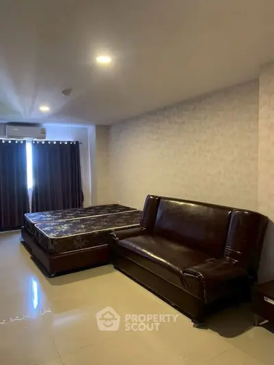 Spacious bedroom with modern furnishings and natural light