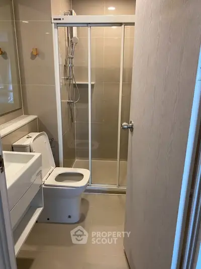Modern bathroom with sleek shower and contemporary fixtures in a stylish apartment.