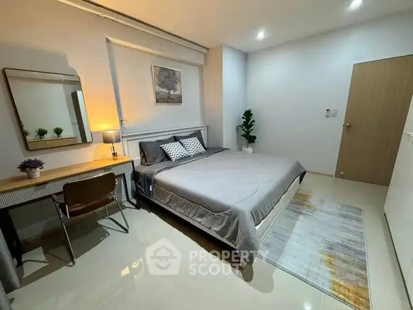 Modern bedroom with stylish decor, cozy lighting, and sleek furnishings.