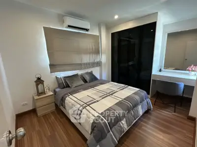 Modern bedroom with stylish decor and wooden flooring