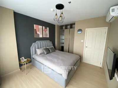 Modern bedroom with stylish decor and ample natural light, featuring a cozy bed and elegant furnishings.