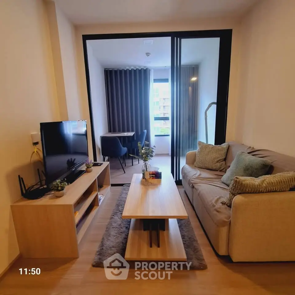 Modern living room with cozy sofa and TV, featuring a stylish open layout and natural light.
