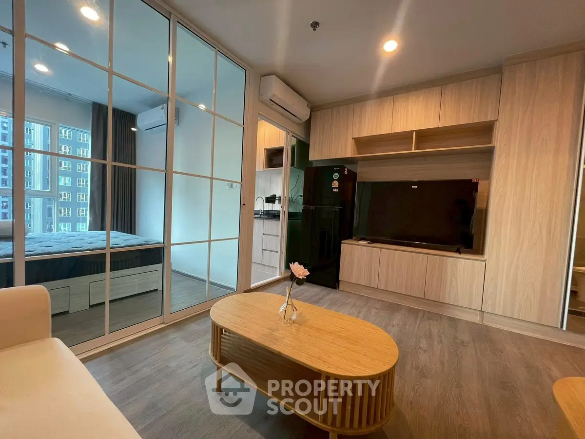 Modern living room with wooden furniture and open view to bedroom
