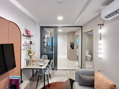 Modern living room with stylish decor and open layout, featuring dining area and cozy seating.