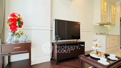 Elegant living room with modern TV setup and stylish kitchen in luxury apartment