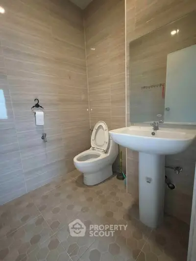 Modern bathroom with sleek fixtures and neutral tile design