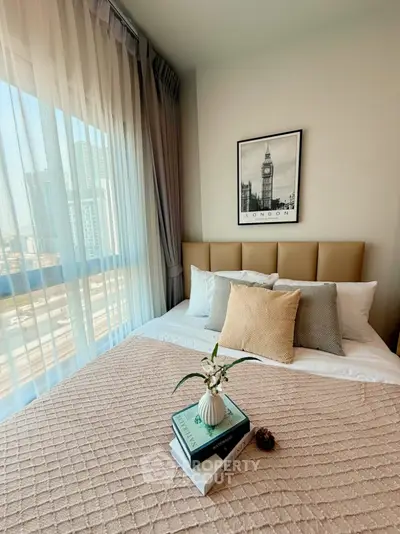 Cozy bedroom with city view, stylish decor, and natural light