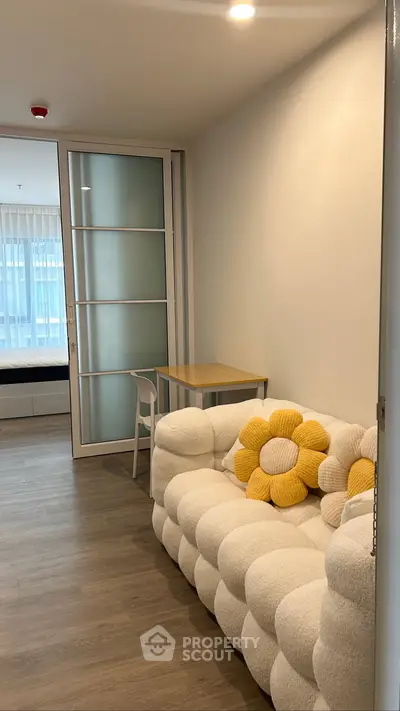 Cozy living room with plush sofa and modern decor in a stylish apartment.