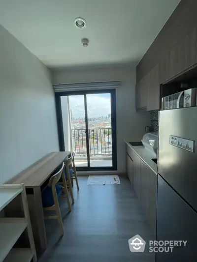 Modern kitchen with balcony view in high-rise apartment