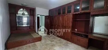 Spacious bedroom with built-in wooden storage and platform bed