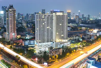 Stunning cityscape view of a modern high-rise building at dusk, showcasing vibrant urban living.