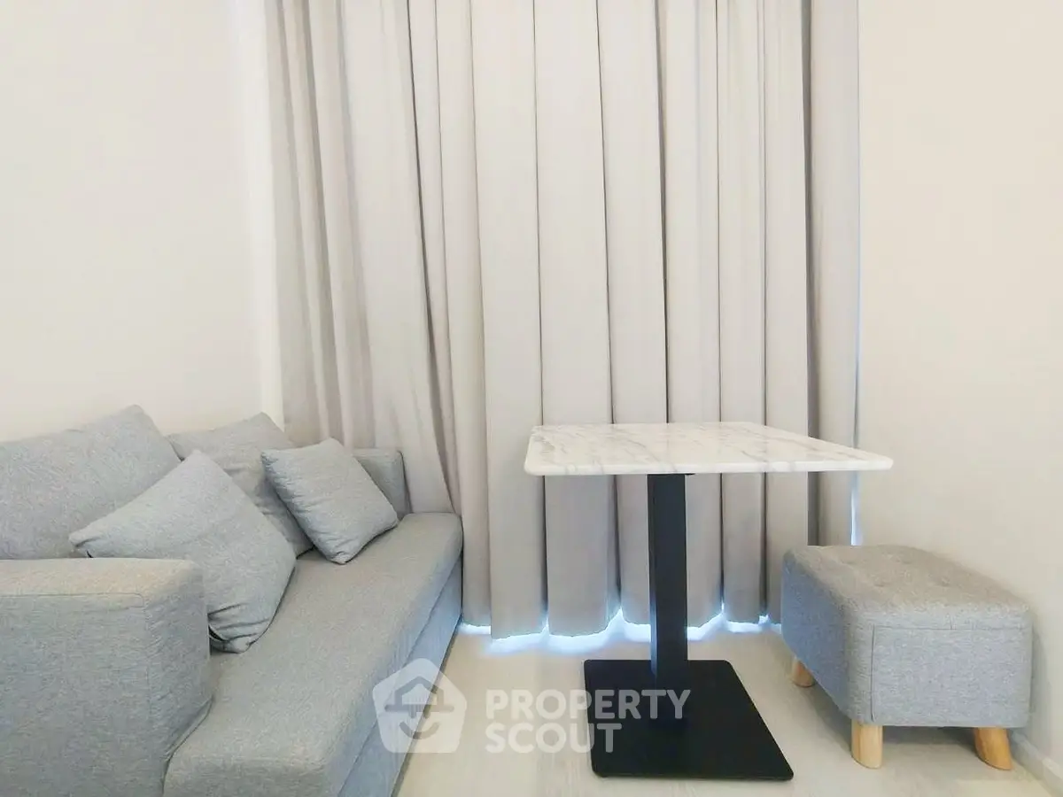 Cozy living room with modern gray sofa and elegant marble table