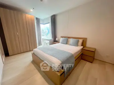 Spacious modern bedroom with city view and elegant wooden furniture