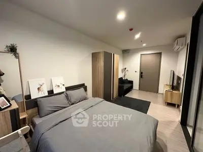 Modern bedroom with stylish decor and cozy ambiance, featuring a comfortable bed and sleek furniture.