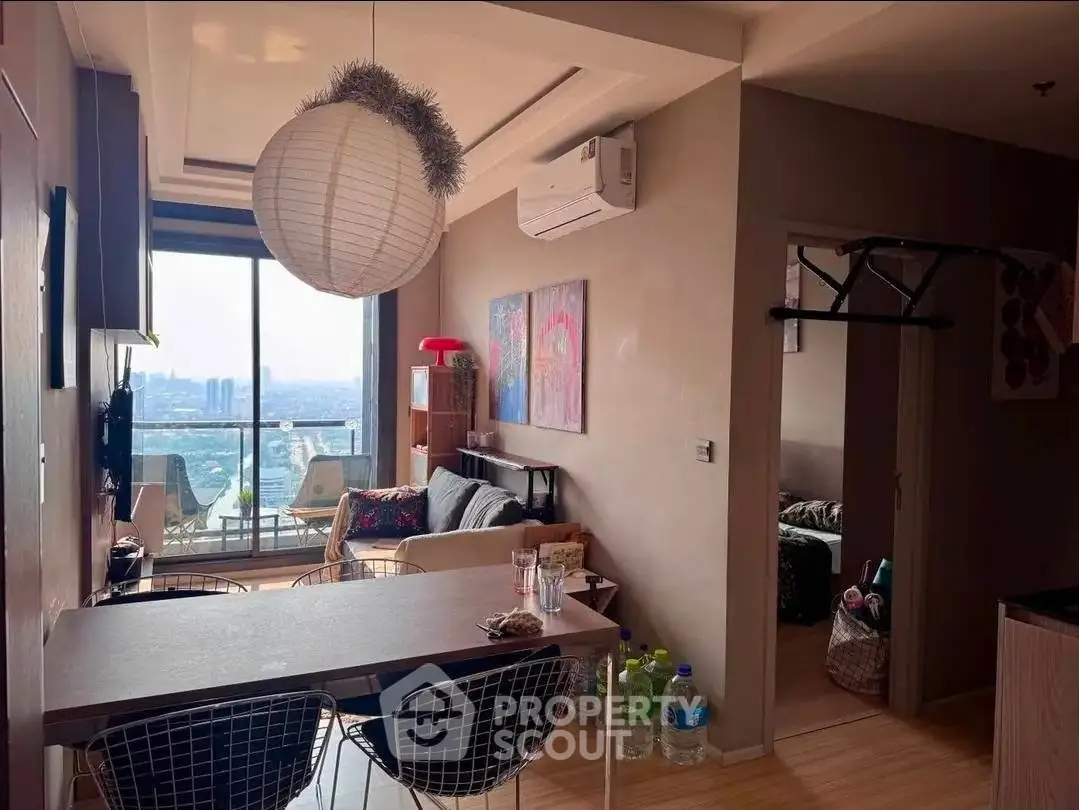 Modern apartment with open layout, stylish decor, and stunning city view from the balcony.
