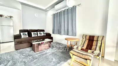 Modern living room with cozy sofa, stylish chair, and sleek decor