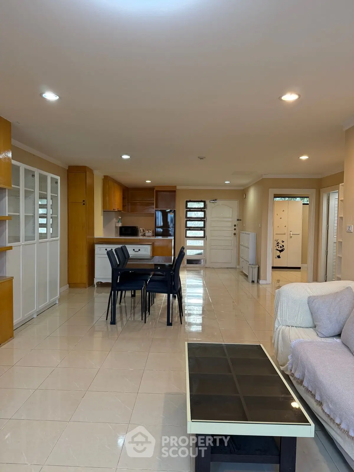 Spacious open-plan living room with modern kitchen and dining area, perfect for family gatherings.