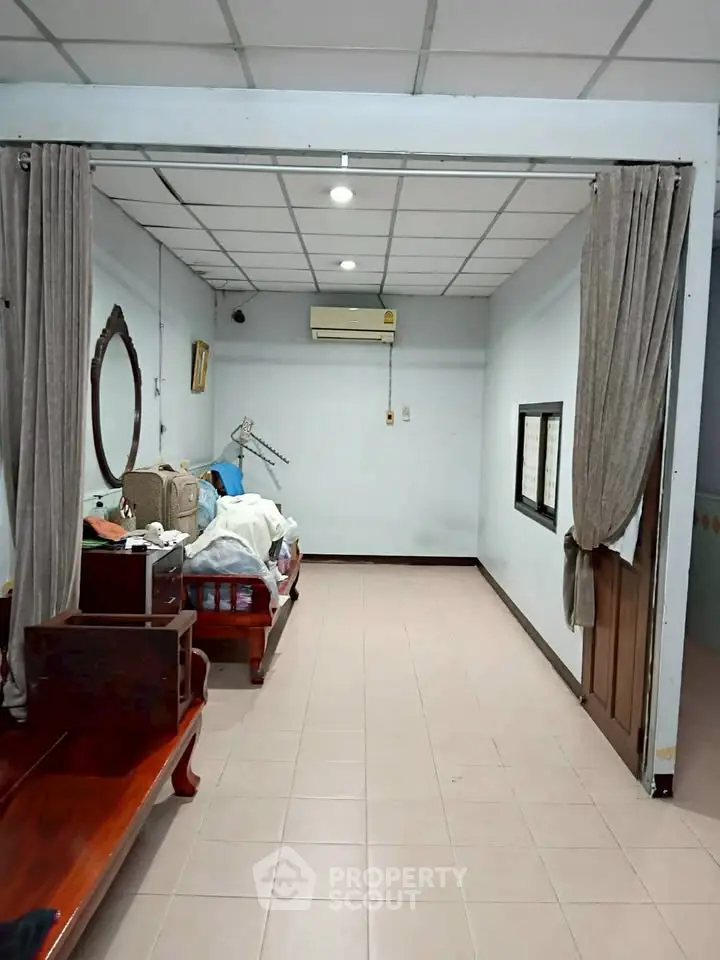 Spacious bedroom with air conditioning and elegant wooden furniture