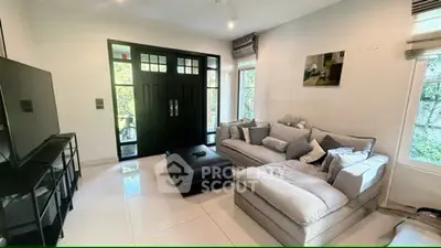 Spacious living room with modern decor and large windows for natural light.