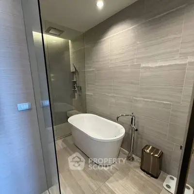 Luxurious modern bathroom with freestanding bathtub and sleek design.