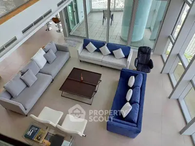 Luxurious high-rise living room with modern sofas and panoramic city views.