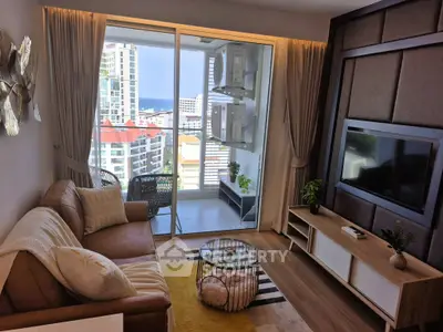 Modern living room with balcony view in high-rise apartment, featuring stylish decor and natural light.