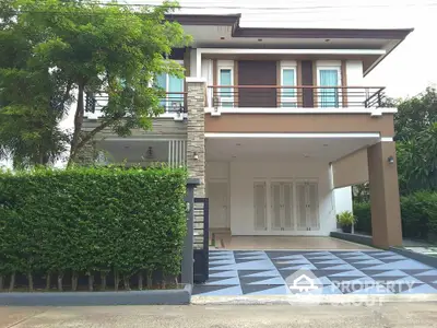 Modern two-story house with spacious driveway and lush greenery, perfect for family living.