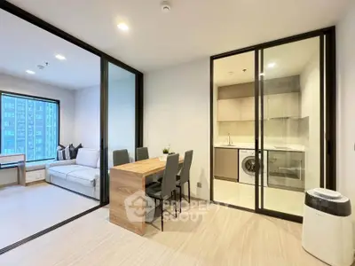 Modern apartment with open layout, featuring a cozy living area and stylish dining space.