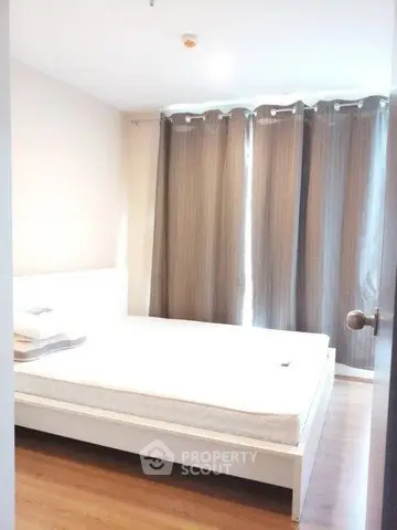 Bright and cozy bedroom with large windows and elegant curtains