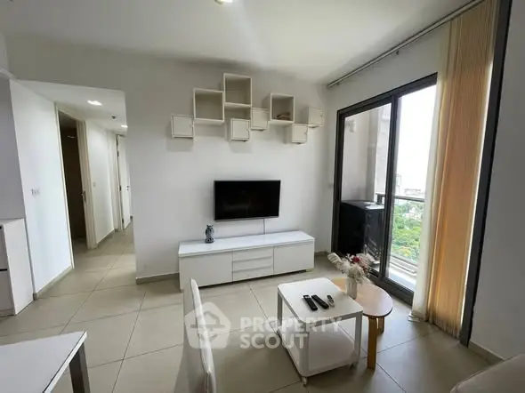 Modern living room with wall-mounted TV and large window view