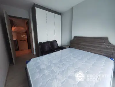 Modern bedroom with stylish furniture and spacious wardrobe in a contemporary apartment.