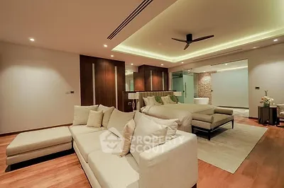 Luxurious modern bedroom with elegant lighting and spacious seating area