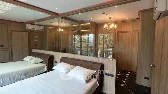 Luxurious bedroom with mirrored walls and elegant lighting