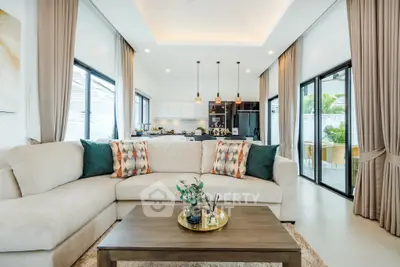 Luxurious open-plan living room with modern kitchen and elegant decor