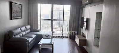 Modern living room with sleek furniture and city view from balcony.