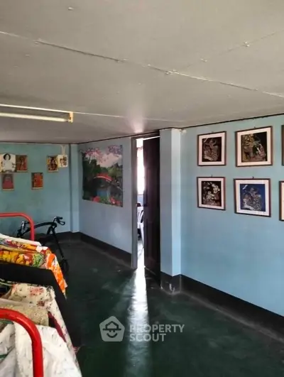 Charming interior hallway with vibrant artwork and cozy atmosphere, perfect for creative inspiration.