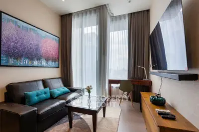 Modern living room with large window, stylish decor, and comfortable seating in a high-rise apartment.