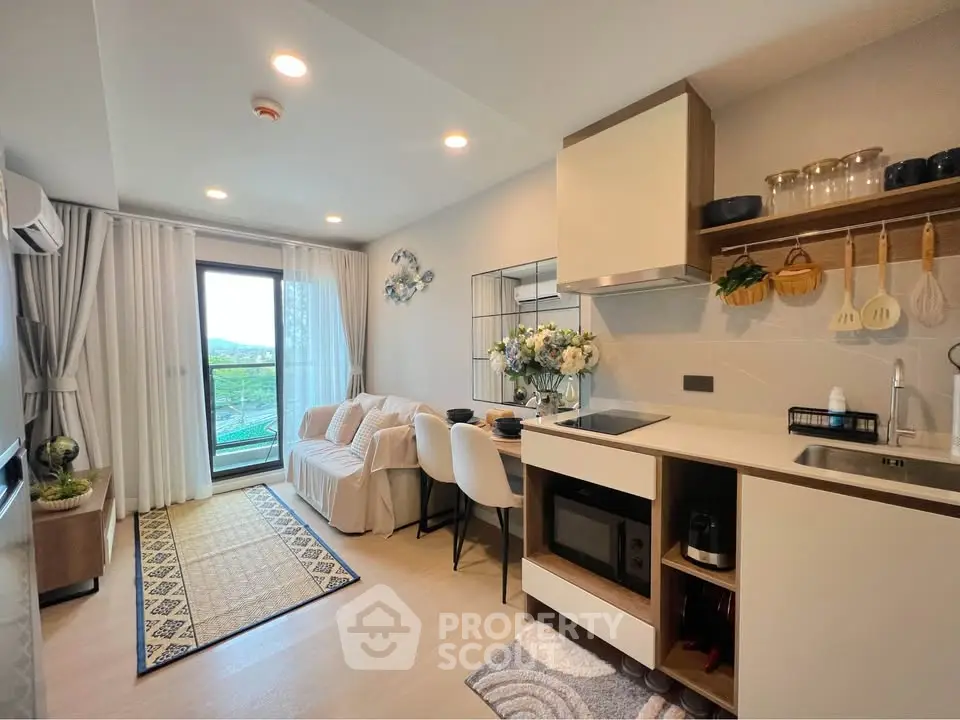 Modern open-layout kitchen and living area with balcony view