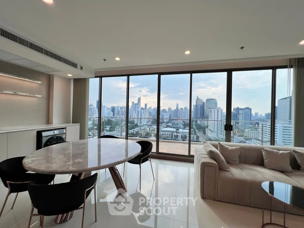 Luxurious living room with panoramic city view, modern furniture, and elegant dining area in high-rise apartment.
