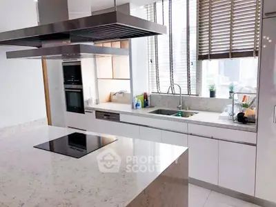 Modern kitchen with sleek countertops and built-in appliances in a bright, airy space.