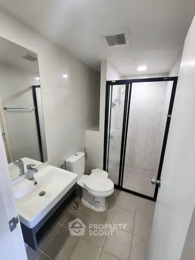Modern bathroom with sleek fixtures and glass shower enclosure